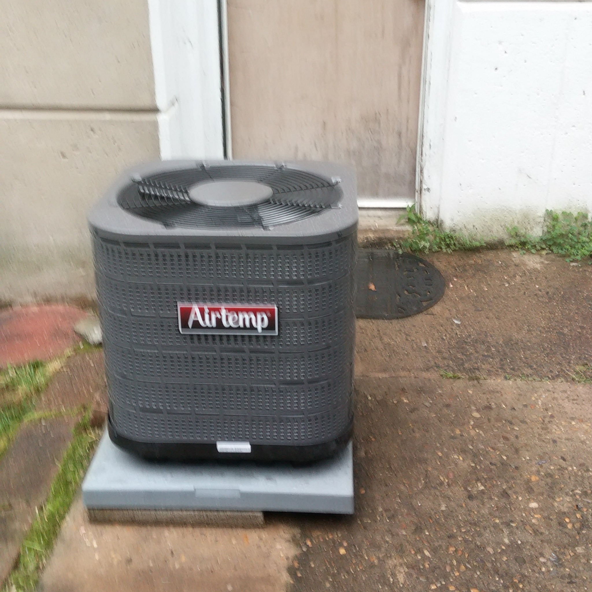 Installed outdoor air conditioning condenser by Bell Heating and AC